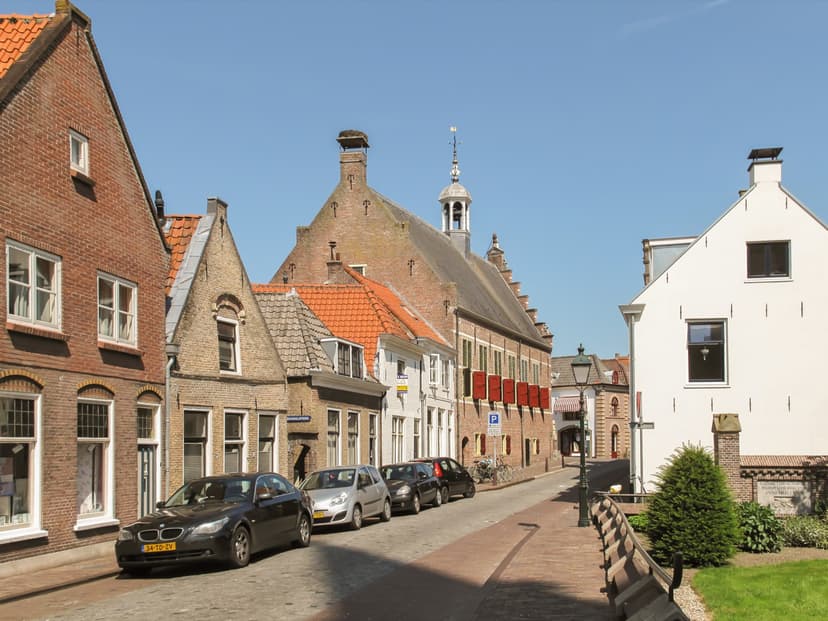 Straatje in de binnenstad van Oudewater met het oude stadhuis met rode luiken