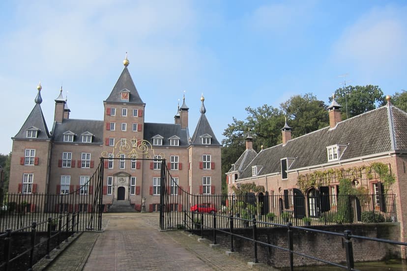 Kasteel Renswoude met het sierlijke toegangshek, de brug over de gracht en het bouwhuis ernaast